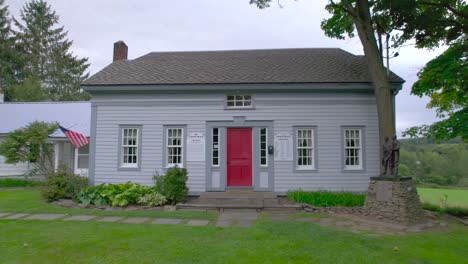 Backing-from-the-door-Drone-shot-of-the-Joseph-Knight-Sr-home-in-Mormon-history