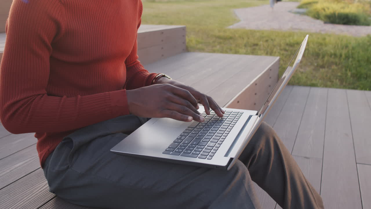 Hands of African American Business Man Typing on Laptop Outdoors