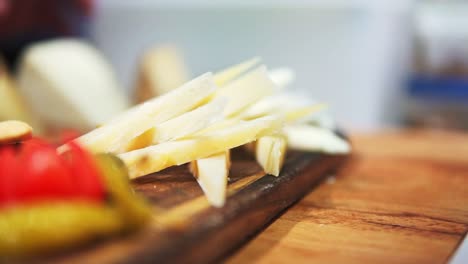 macro shot of person preparing cheese platter to be served in restaurant