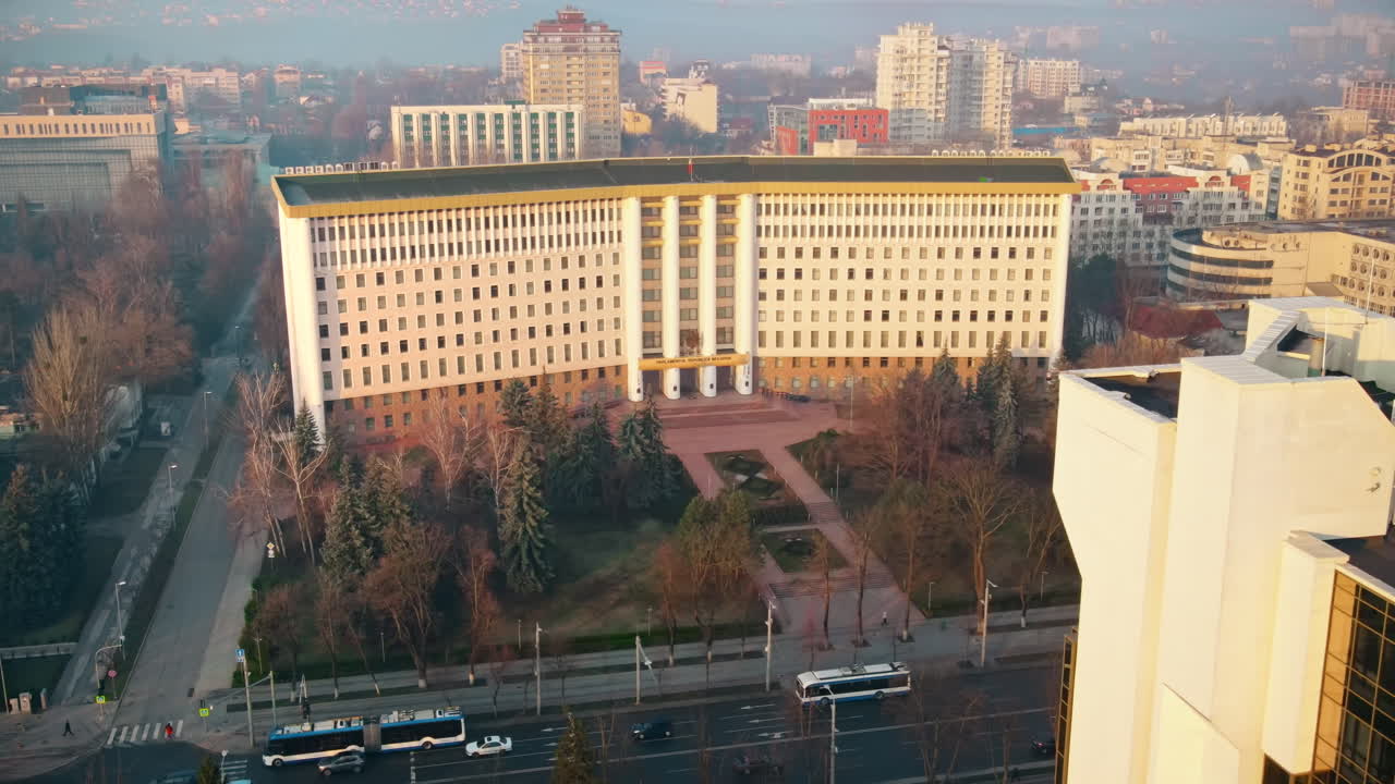 Aerial drone view of Chisinau downtown. View of Parliament and Presidency, roads with moving cars and bare trees. Sunny weather. Moldova