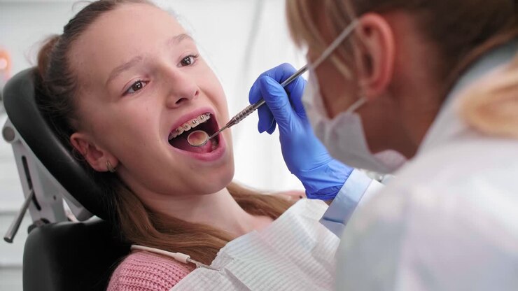 Dentist&#039;s hand using dental mirror during checkup