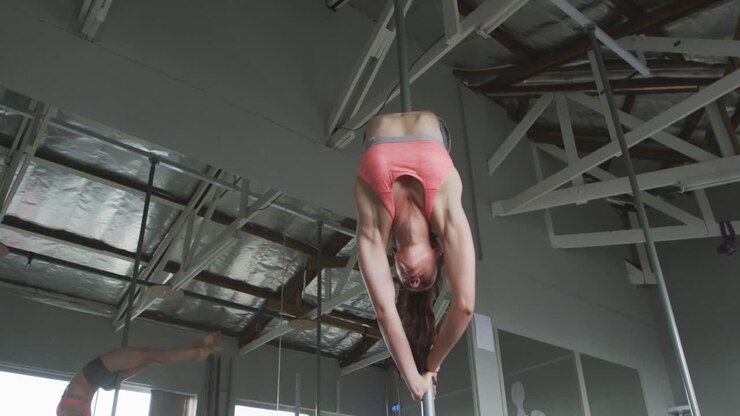 Caucasian woman doing pole dancing
