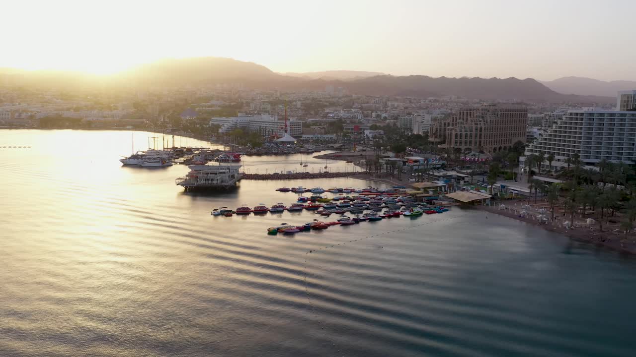 Aerial view of sunset over boats and luxury hotels at Eilat’s coastline, Israel