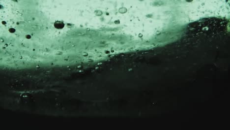 high speed slow motion of oil flowing in water bubbles slowly rises upwards