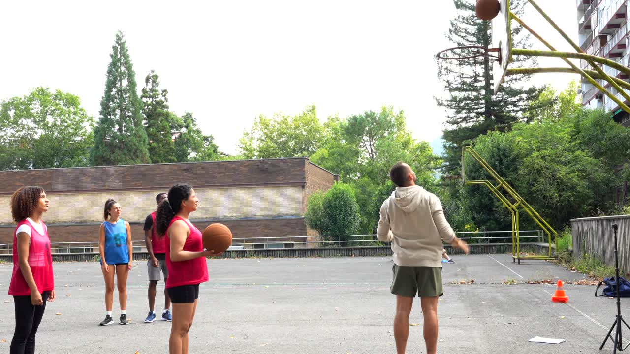 People playing basketball outdoors