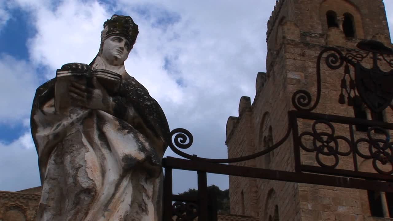 이탈리아 체팔루에서 책을 들고 있는 여인상 위로 움직이는 구름의 시간 경과