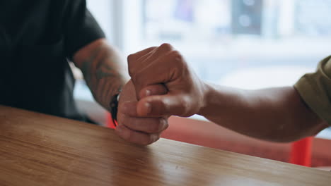 two men hands touching tenderly at romantic meeting in cafe feeling love closeup