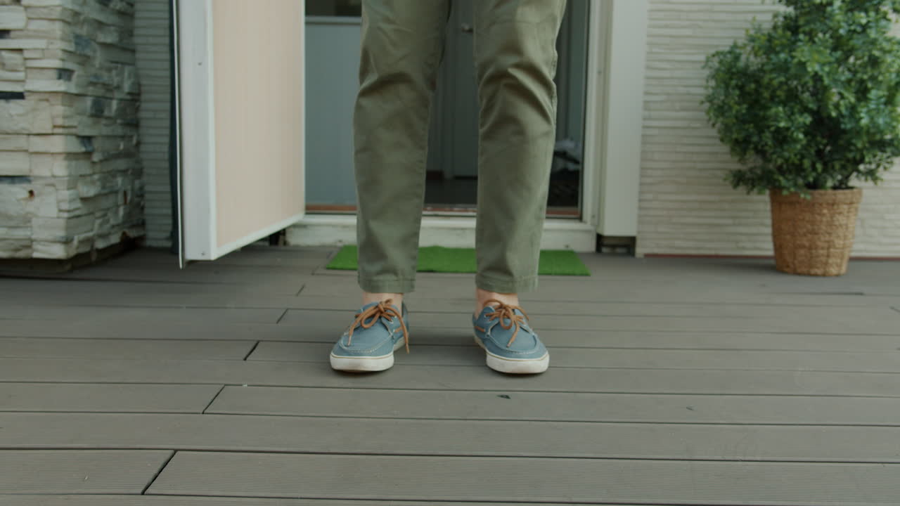 Person Walking Out of a House