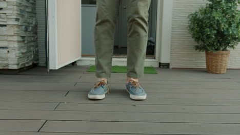 person walking out of a house