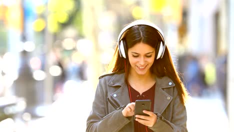 teen listening to music walking in the street