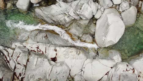 aerial view of a mountain river flowing through white rocks