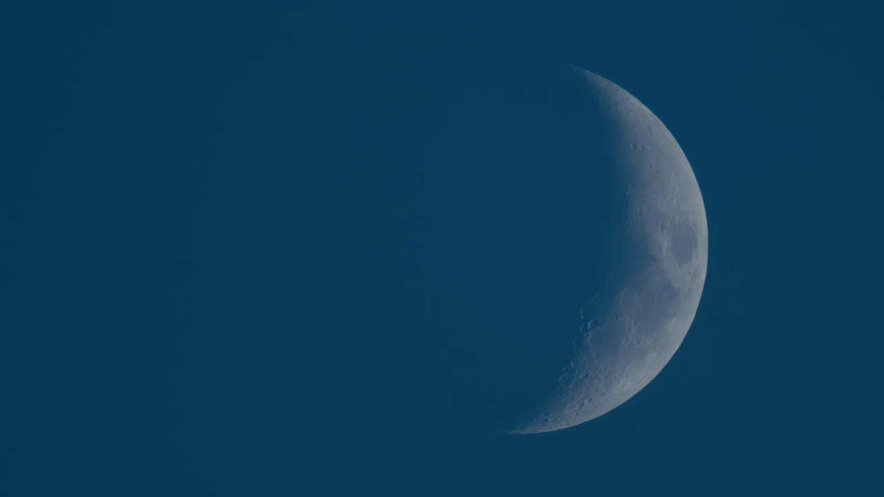 Close up of crescent moon illuminated against a deep blue sky