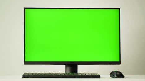 computer setup with green screen monitor