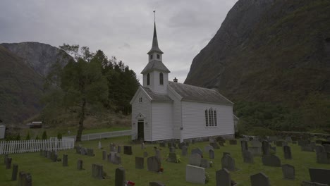 Steady-footage-of-beautiful-small-church-in-Norway-surrounded-by-gravestones