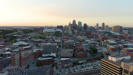 aerial pullback reveals kansas city skyscrapers during summer sunset