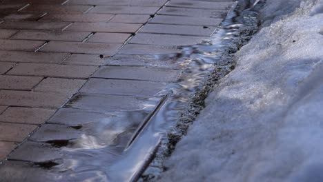 melted snow on paving stones. thaw in early spring.