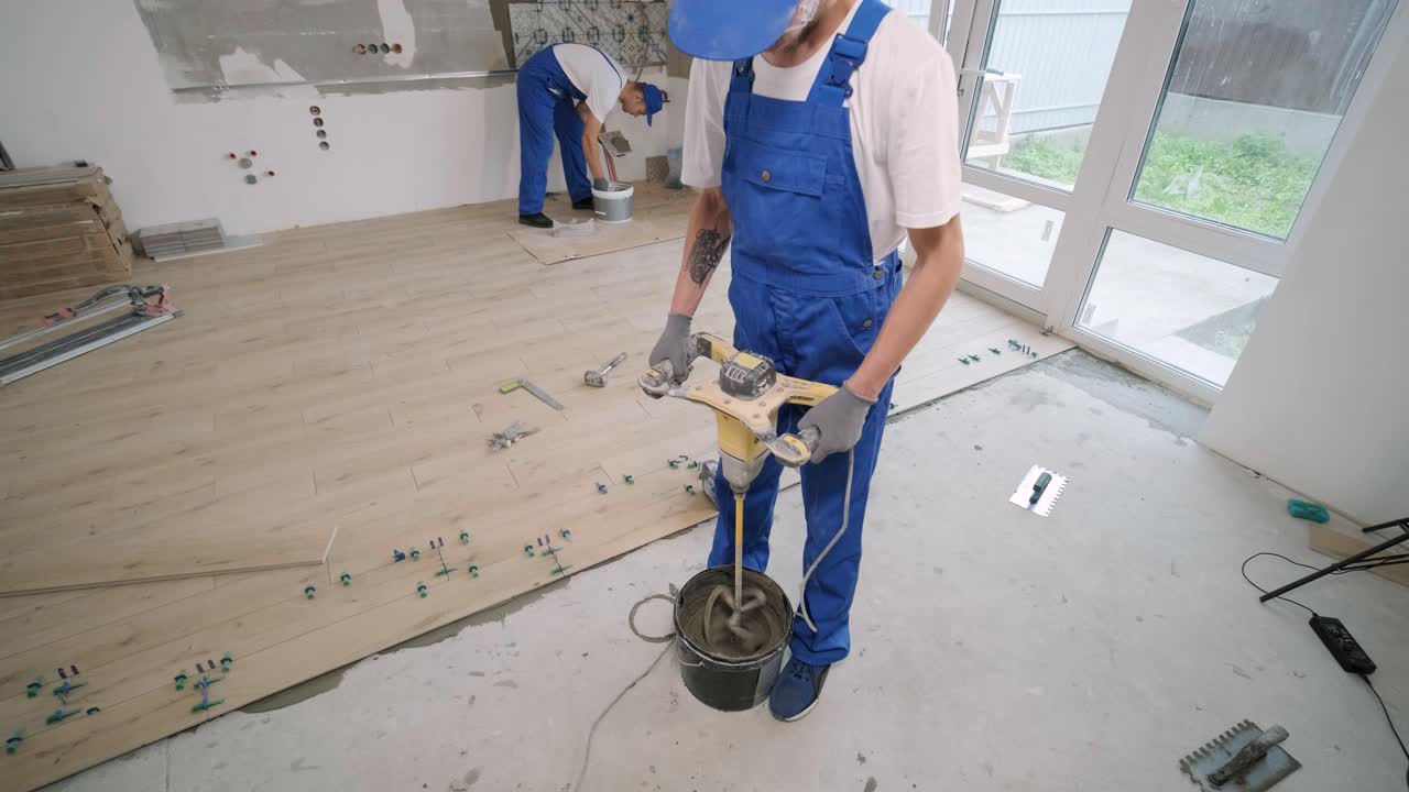 Construction, renovation, repair apartment. Installing ceramic floor tiles - measuring and cutting the pieces. Cuts tile. Tile cutting