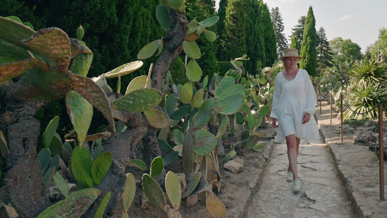 Woman walking in a cactus garden