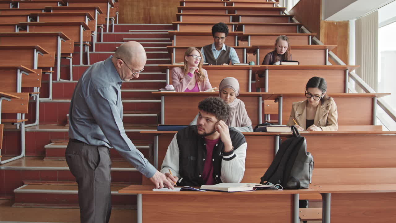 Male Professor Helping Students during Lesson