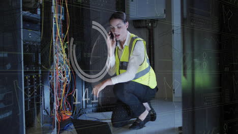 Animation-of-data-processing-over-caucasian-female-it-technician-with-laptop-over-computer-servers