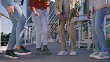group of students walking on a bridge