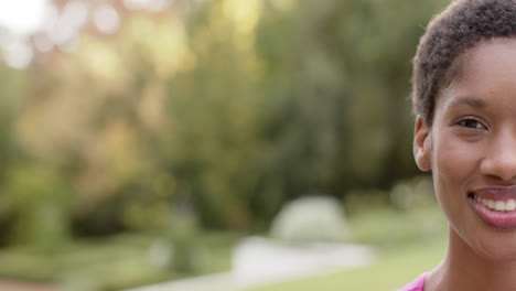 Portrait-of-happy-african-american-woman,-smilling-in-garden,-copy-space,-in-slow-motion