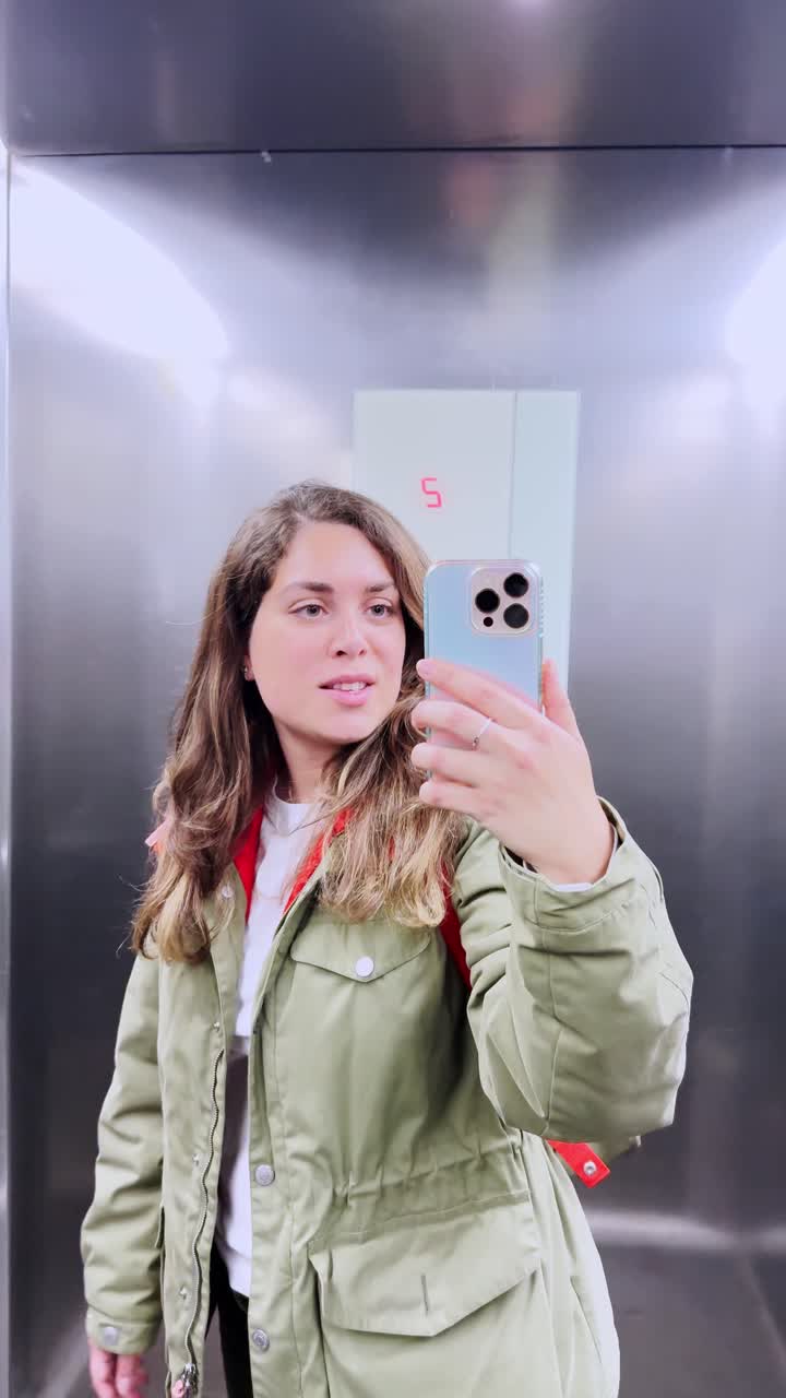 Young Woman Taking a Selfie Video in a Modern Elevator