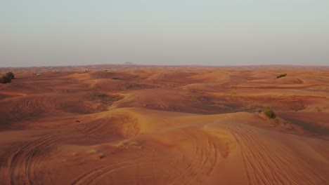 desert landscape with sand dunes and vehicle tracks