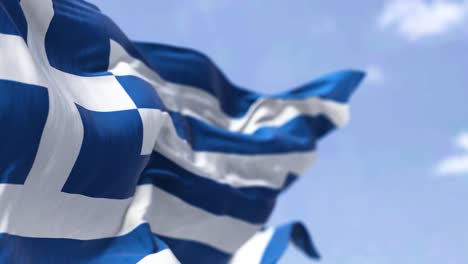 detail of the national flag of greece waving in the wind on a clear day