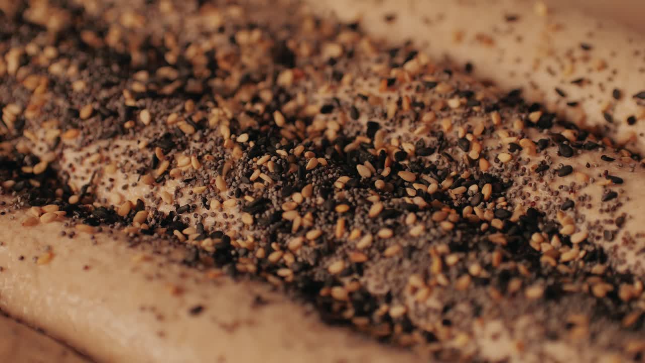 Bakery chef making fresh Artesian buns and baguettes using traditional recipe close-up. Young man kneading dough. Artisan bread is making by skill bakers using natural and high-quality ingredients. Food with health and flavour benefits. Bakery shop and market