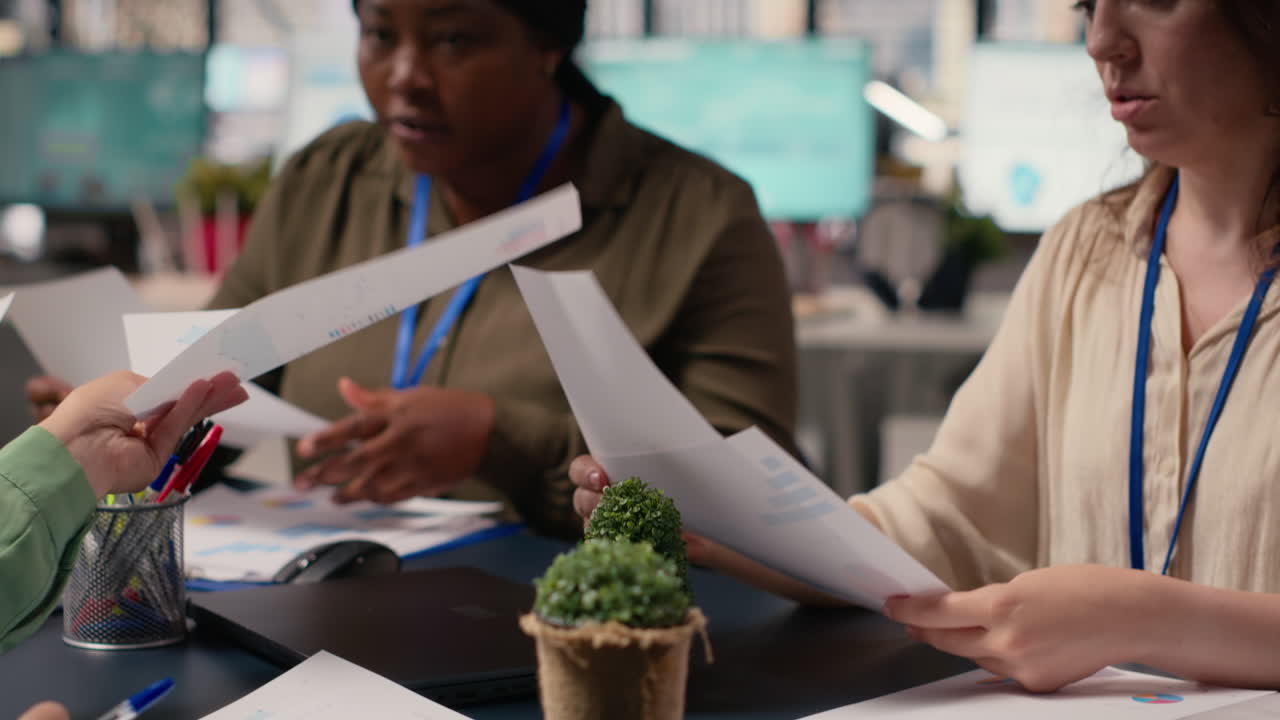 Vertical Video Diverse business associates exchanging data files in a briefing meeting