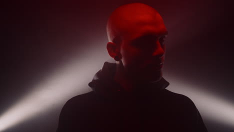 dramatic portrait of a bald man in red light