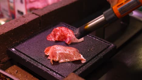 steak being seared on a hot stone grill