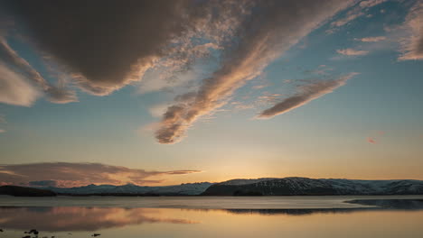 sun setting over the calm lake with vatnajokull glacier on the background in south iceland. -timelapse