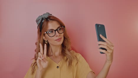 woman taking selfie with peace sign