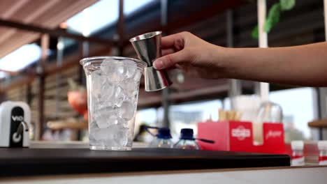 preparing an iced orange juice drink