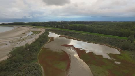 Aerial:-Nature-located-next-to-a-port-in-Vlissingen,-the-Netherlands