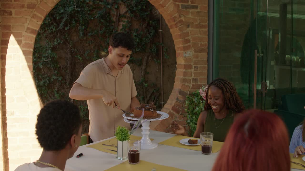 Friends enjoy cake at an outdoor social gathering