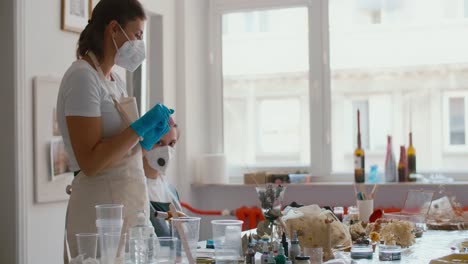 woman in a workshop making floral resin art