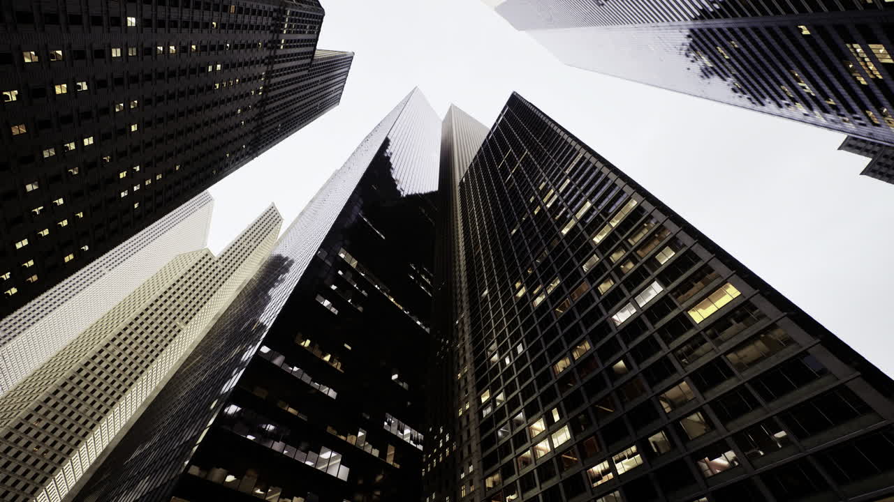 Urban skyscrapers create a dramatic perspective in a bustling city skyline
