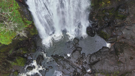 4k drone footage flying over majestic waterfall in the pacific northwest america