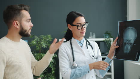 doctor explaining skull x-ray to patient