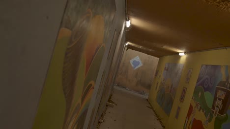 rack focus of warm yellow tunnel full of art pieces
