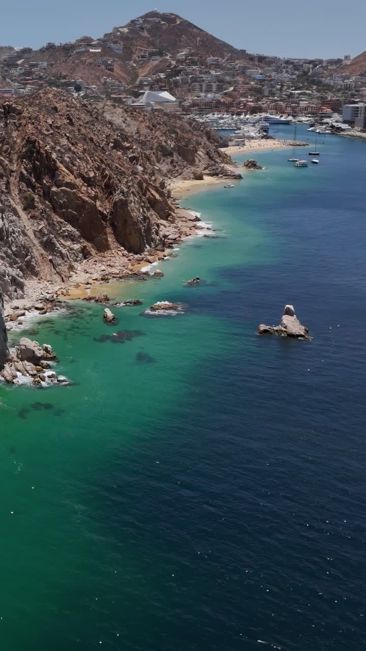 Vertical Aerial View of Cabo San Lucas, Mexico, Coastline, Harbor Marina and Buildings, Revealing Drone Shot