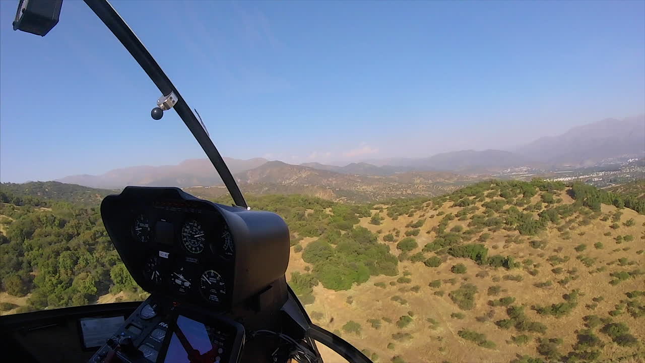 Helicoper flying low in the mountins, shoot from the inside, in Full HD at 60fps
