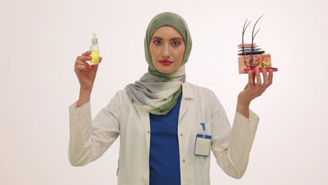a female dermatologist in hijab demonstrates skin anatomy with model and skincare product