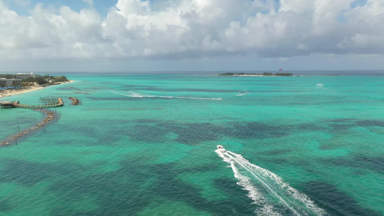 Bahamas, Nassau. Aerial View of Speedboat Sailing on Turquoise Tropical Sea Water by White Sand Beach Coast