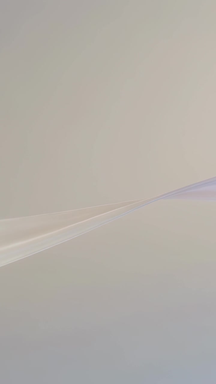 Vertical video: Sliding ribbon shifting right on play over pale gradient, creating calm motion