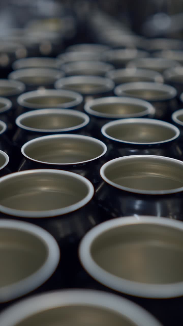 Rows of empty metal cans in a factory