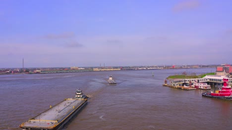 busy barges in the mississippi river in new orleans